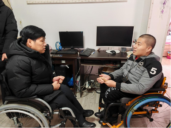 图为省残联党组成员、副理事长刘懿（左一）详细询问残疾人生产生活情况