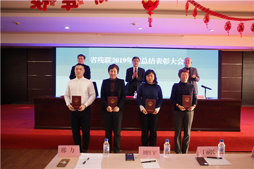 图为省残联领导为优秀公务员颁发证书