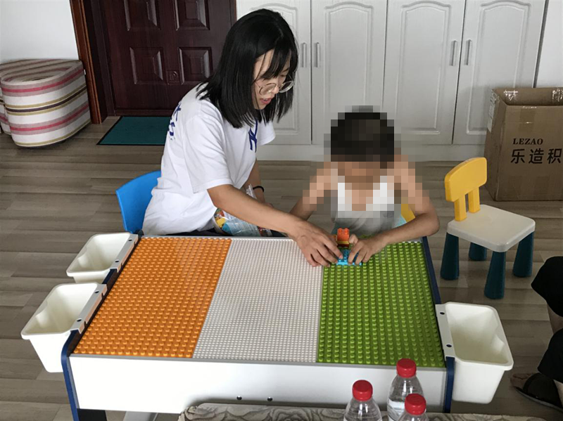 图为孤独症项目白阳老师进行家庭教学活动 图为孤独症项目白阳老师进行家庭教学活动